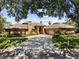Beautiful brick home featuring a tile roof, well manicured landscaping, a circular driveway and a separate two-car garage at 3772 Woodridge Pl, Palm Harbor, FL 34684