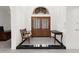 Elegant foyer features marble floors, a decorative glass door, and classic furniture at 3772 Woodridge Pl, Palm Harbor, FL 34684