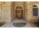 Close up of a custom front door with a decorative brick surround at 3772 Woodridge Pl, Palm Harbor, FL 34684