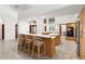 Well-lit kitchen with breakfast bar, white countertops, and neutral-toned cabinets at 3772 Woodridge Pl, Palm Harbor, FL 34684