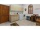 Functional laundry room features a washer, dryer, sink, and ample storage space at 3772 Woodridge Pl, Palm Harbor, FL 34684