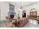 Open living room showcases stone fireplace, tiled floors, and french doors at 3772 Woodridge Pl, Palm Harbor, FL 34684