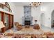 Bright living room with stone fireplace, chandelier, and french door access at 3772 Woodridge Pl, Palm Harbor, FL 34684