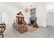 Bright living room with stone fireplace, chandelier, and french door access at 3772 Woodridge Pl, Palm Harbor, FL 34684