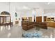 Open-concept living room featuring tile flooring, high ceilings, and a built-in bar area at 3772 Woodridge Pl, Palm Harbor, FL 34684