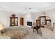 Spacious main bedroom with fireplace and french doors to the exterior at 3772 Woodridge Pl, Palm Harbor, FL 34684
