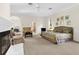 Bright main bedroom featuring a fireplace, sitting area, and large windows at 3772 Woodridge Pl, Palm Harbor, FL 34684