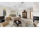 Bright main bedroom featuring a fireplace, sitting area, and large windows at 3772 Woodridge Pl, Palm Harbor, FL 34684