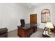Home office boasts a spacious desk, natural light, and a ceiling fan at 3772 Woodridge Pl, Palm Harbor, FL 34684