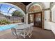 Covered patio overlooking the pool and screened-in lanai area at 3772 Woodridge Pl, Palm Harbor, FL 34684