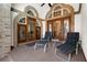 Covered patio with brick archways and decorative doors, providing a cozy outdoor seating area at 3772 Woodridge Pl, Palm Harbor, FL 34684