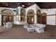 Spacious covered patio featuring brick columns, ceiling fans, comfortable seating, and a dining area at 3772 Woodridge Pl, Palm Harbor, FL 34684