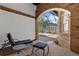 Covered patio with brick columns and a view of the screened in pool and green shrubs at 3772 Woodridge Pl, Palm Harbor, FL 34684