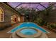 Sparkling pool and spa surrounded by lush landscaping and a screened enclosure for year-round enjoyment at 3772 Woodridge Pl, Palm Harbor, FL 34684