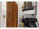 Utility closet with wooden louvered doors, housing a water heater and equipment for home maintenance at 3772 Woodridge Pl, Palm Harbor, FL 34684