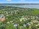 Aerial view of a beautiful property surrounded by trees and near a bay; a pin indicates property location at 39 Bishop Creek Dr, Safety Harbor, FL 34695