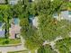 Aerial view of the property, highlighting the house, pool, and surrounding mature trees at 39 Bishop Creek Dr, Safety Harbor, FL 34695