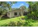 Large backyard showcasing the home's exterior, landscaping, and screened-in pool area at 39 Bishop Creek Dr, Safety Harbor, FL 34695