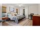 Comfortable bedroom with wood-look floors, ample natural light, and a modern ceiling fan at 39 Bishop Creek Dr, Safety Harbor, FL 34695