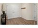 Inviting entryway showcasing double doors, wood-look floors, and coat rack at 39 Bishop Creek Dr, Safety Harbor, FL 34695