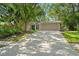 Charming single-story home with a well-manicured lawn, mature trees, and a welcoming front entrance at 39 Bishop Creek Dr, Safety Harbor, FL 34695