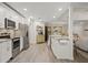 Open kitchen with white cabinets, stainless steel appliances, and a view of the living area at 39 Bishop Creek Dr, Safety Harbor, FL 34695