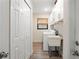 Laundry room featuring a utility sink, washer, dryer, cabinets, and wood-look floors at 39 Bishop Creek Dr, Safety Harbor, FL 34695