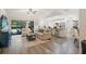 Open-concept living room with modern decor, seamlessly connecting to the kitchen and outdoor pool area at 39 Bishop Creek Dr, Safety Harbor, FL 34695