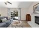 Living room features a stone fireplace, sliding glass doors to the pool area, and wood-look floors at 39 Bishop Creek Dr, Safety Harbor, FL 34695