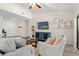 Cozy living room featuring a plush sofa, decorative elements, and a sliding glass door to the outdoor area at 39 Bishop Creek Dr, Safety Harbor, FL 34695