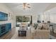 Well-lit living room featuring a large sofa, a cozy armchair, and sliding glass doors to the patio at 39 Bishop Creek Dr, Safety Harbor, FL 34695