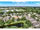 Aerial view of homes near a pond, showcasing the neighborhood's layout and proximity to schools at 406 Laguna Mill Dr, Ruskin, FL 33570