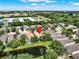Home with landscaped backyard, small pond, and mature trees in a quiet residential neighborhood at 406 Laguna Mill Dr, Ruskin, FL 33570