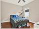 Bedroom with hardwood floors, a ceiling fan, and a pet play structure at 406 Laguna Mill Dr, Ruskin, FL 33570