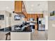 Open kitchen with granite counters, stainless appliances and warm wood cabinets at 406 Laguna Mill Dr, Ruskin, FL 33570