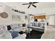 Spacious living room featuring two plush grey couches, sleek ceiling fan, and unique decor at 406 Laguna Mill Dr, Ruskin, FL 33570