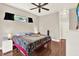 Neutral main bedroom featuring wood floors, a ceiling fan, and abundant natural light at 406 Laguna Mill Dr, Ruskin, FL 33570