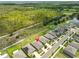 Aerial shot shows the home in proximity to nature with a backdrop of green trees, and nearby lush community at 4485 Eternal Prince Dr, Sun City Center, FL 33573
