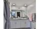 Bathroom featuring double sinks with granite countertops, framed mirror, and decorative accents at 4485 Eternal Prince Dr, Sun City Center, FL 33573