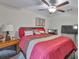 Inviting bedroom featuring a ceiling fan, fireplace, soft carpet, and stylish decor providing a comforting space at 4485 Eternal Prince Dr, Sun City Center, FL 33573