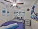 Bedroom boasts ceiling fan, soft carpet, and modern artwork for a stylish and relaxing environment at 4485 Eternal Prince Dr, Sun City Center, FL 33573