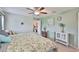 Charming bedroom with ceiling fan, floral bedding, and decorative accents provides a cozy retreat at 4485 Eternal Prince Dr, Sun City Center, FL 33573