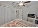 Cozy bedroom with a ceiling fan, double closet, desk, and plush carpeting for a relaxing atmosphere at 4485 Eternal Prince Dr, Sun City Center, FL 33573