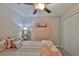 Comfortable bedroom with a ceiling fan, soft carpet, and ample closet space, perfect for relaxation at 4485 Eternal Prince Dr, Sun City Center, FL 33573
