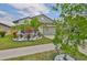 Charming house with a palm tree, landscaping, and a spacious driveway at 4485 Eternal Prince Dr, Sun City Center, FL 33573
