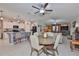 Open floor plan with kitchen featuring white cabinets, a breakfast bar, and stainless steel appliances at 4485 Eternal Prince Dr, Sun City Center, FL 33573