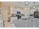 Bright kitchen featuring granite countertops, stainless steel sink, and white cabinetry at 4485 Eternal Prince Dr, Sun City Center, FL 33573