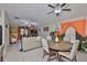 Open living room featuring a ceiling fan, tile floors, and a view into another living area at 4485 Eternal Prince Dr, Sun City Center, FL 33573