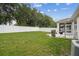 Spacious backyard, perfect for outdoor activities and gatherings with white fence at 518 Winthrop Dr, Spring Hill, FL 34609