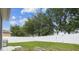 Well-maintained, green backyard with a white vinyl fence for privacy at 518 Winthrop Dr, Spring Hill, FL 34609